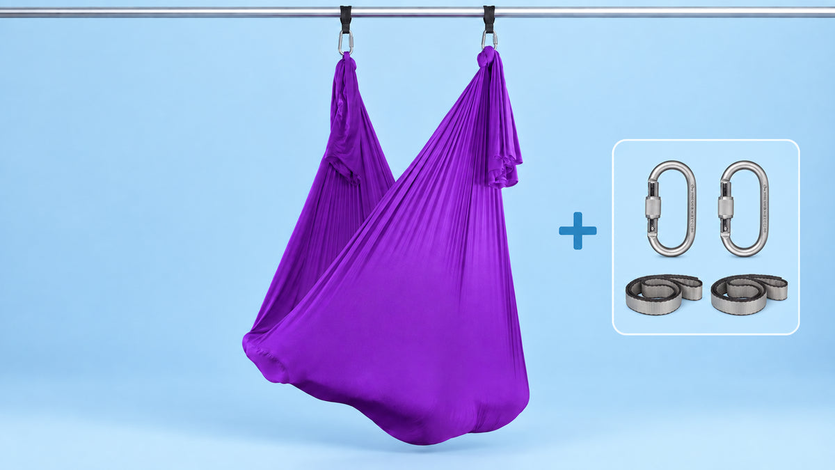 Violetes Aerial-Yoga-Tuch als Hängematte aufgehängt mit zwei Karabinern und zwei Schlingen im Bundle.